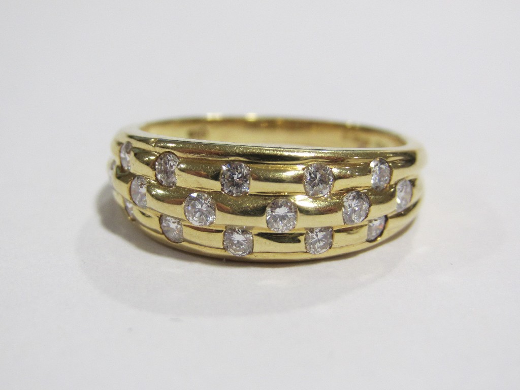 Appraisal: An eighteen carat gold diamond set band with a triple