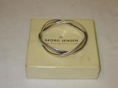 Appraisal: A GEORG JENSEN SILVER BANGLE comprising two entwined circles g