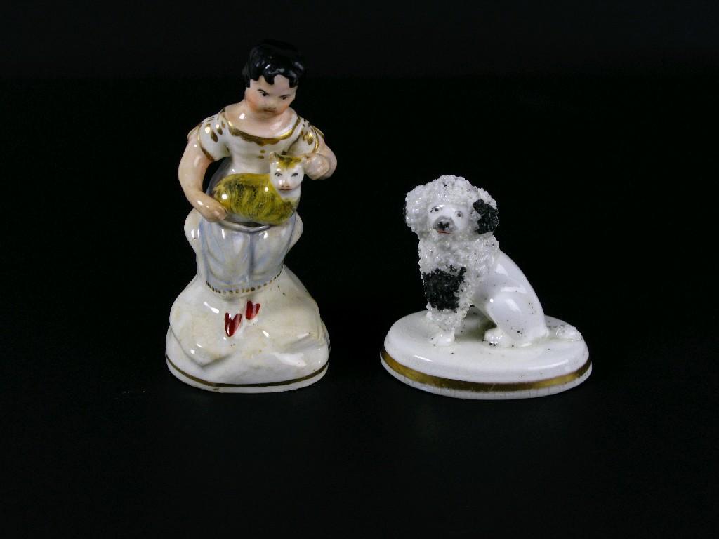 Appraisal: A Staffordshire seated Poodle on oval base in and a