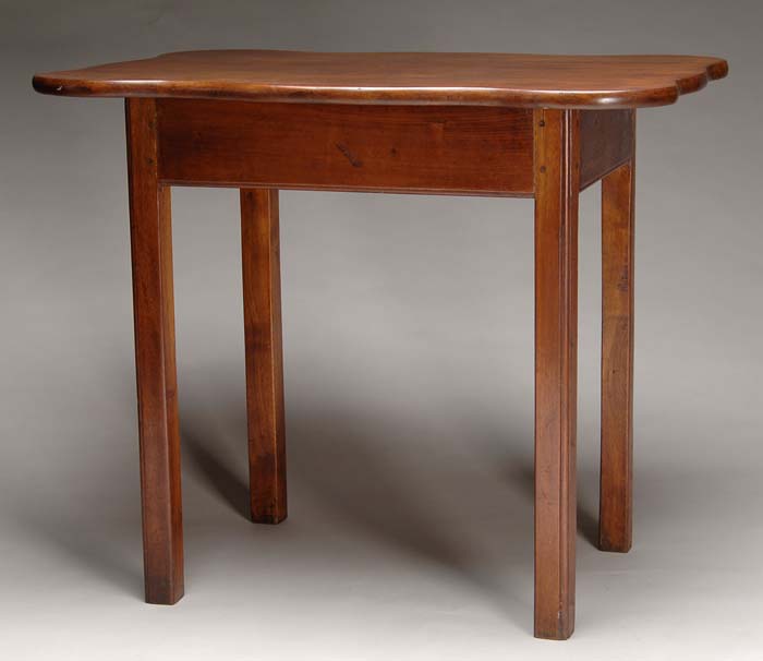 Appraisal: SHAPED TOP CHIPPENDALE MAHOGANY TEA TABLE Square legs having a