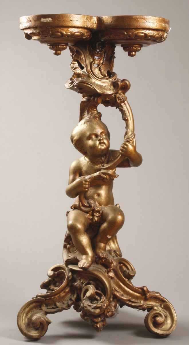 Appraisal: Card stand features putto figure seated on scroll form base