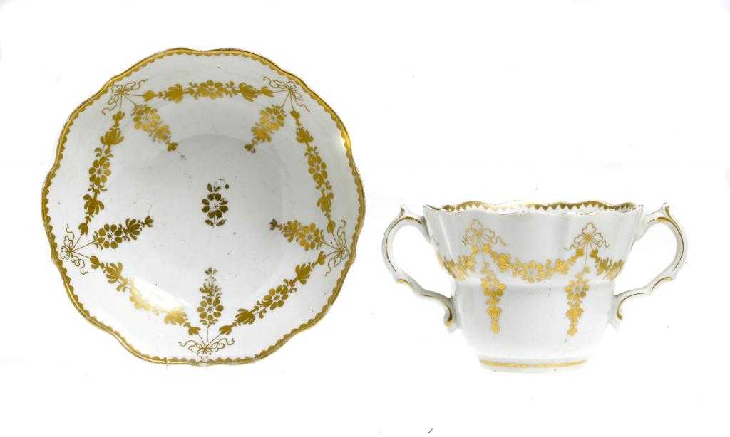 Appraisal: A PAIR OF WORCESTER CHOCOLATE CUPS AND SAUCERS gilt with