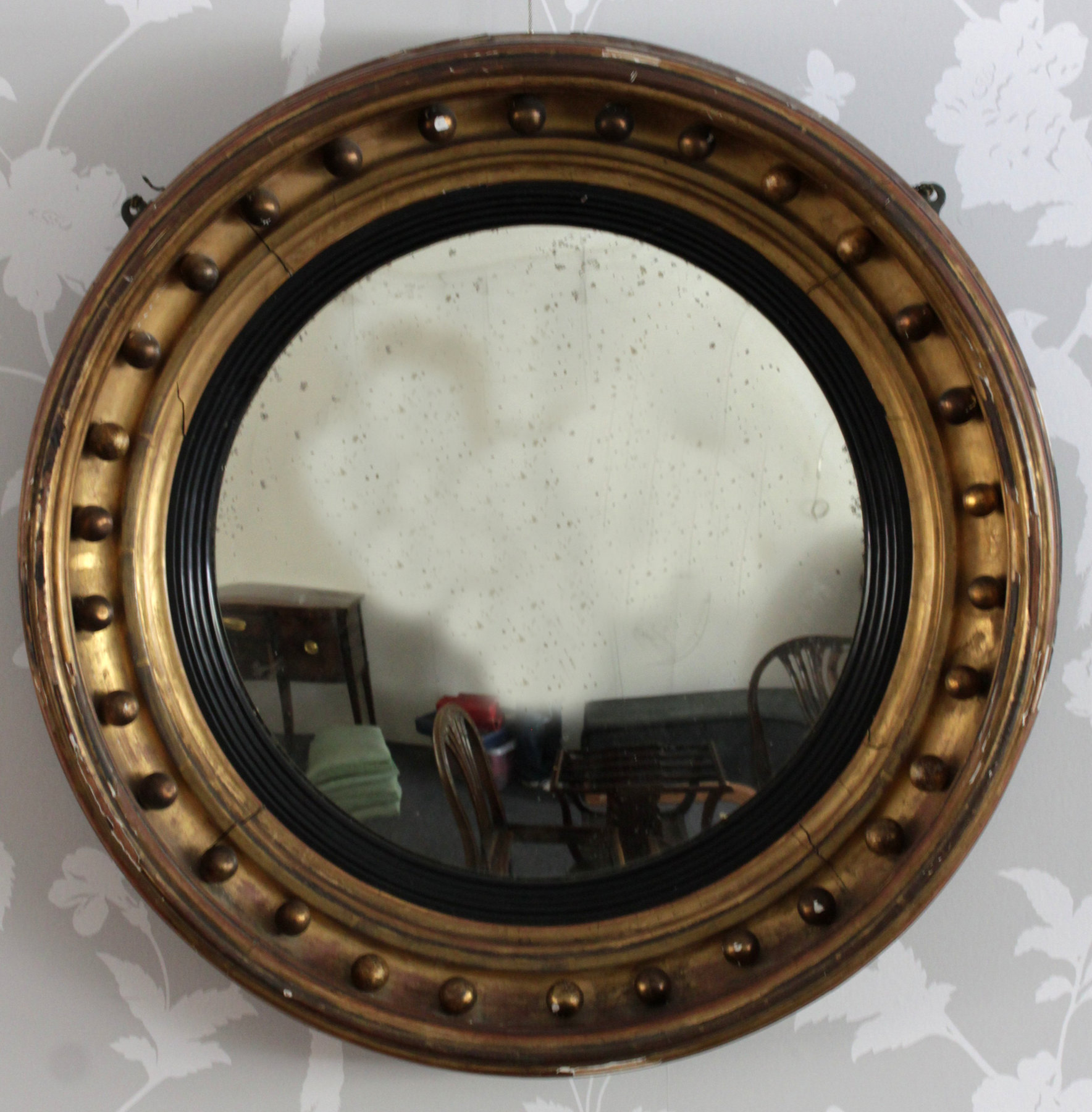 Appraisal: A Regency convex mirror with balls to the moulded circular