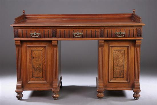 Appraisal: EDWARDIAN WALNUT DOUBLE-PEDESTAL DESK Late th century Three-quarter galleried rectangular