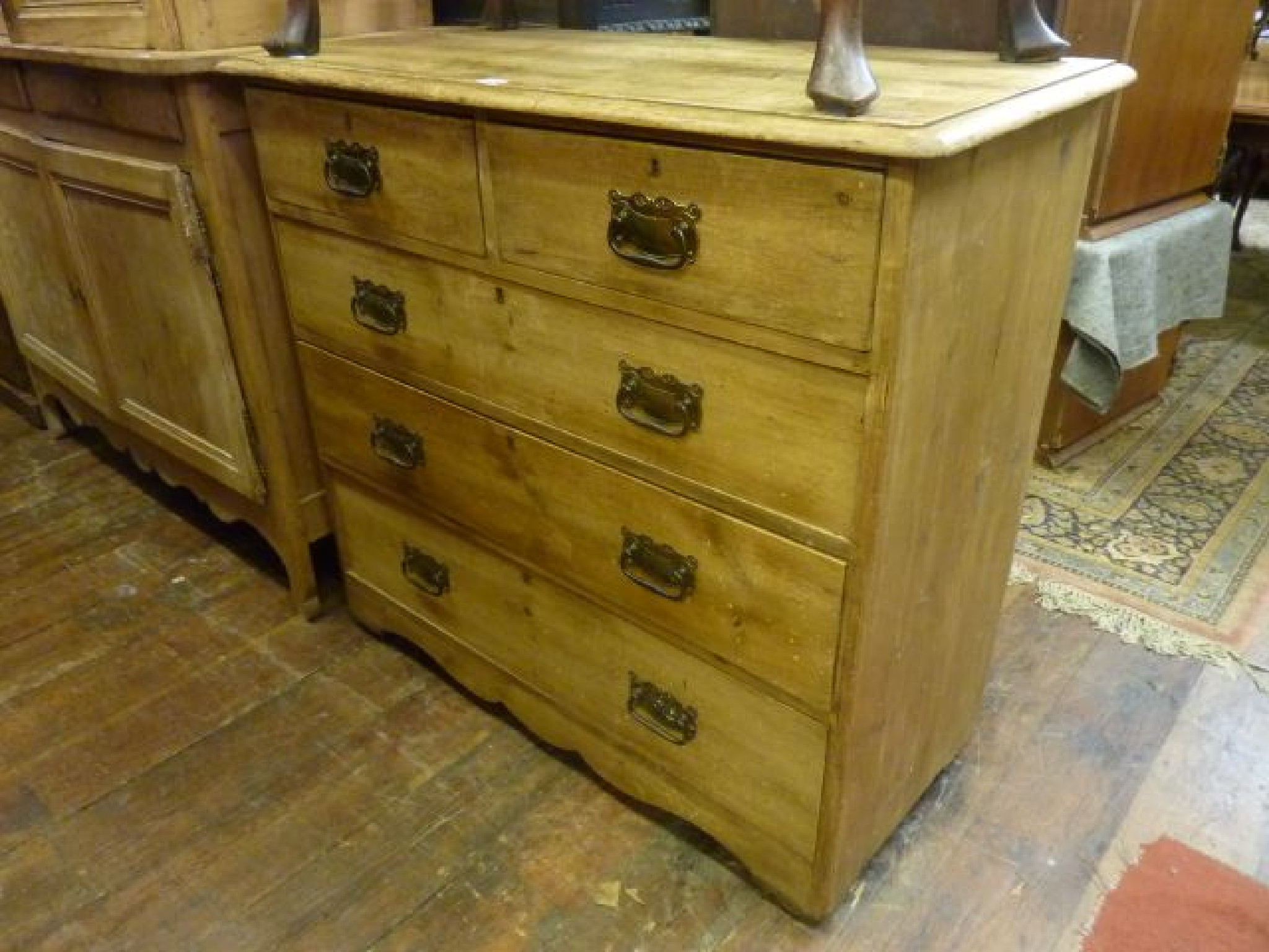 Appraisal: A stripped and waxed pine chest of three long and