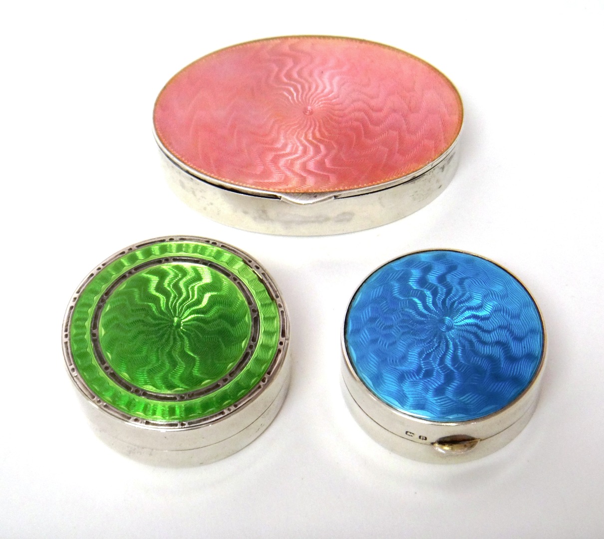 Appraisal: A silver and translucent pink enamelled oval hinge lidded box