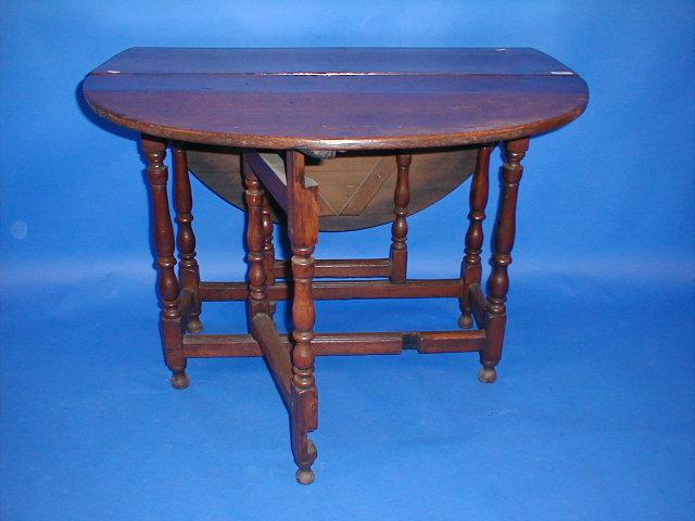 Appraisal: An early thC oak gateleg table with turned uprights and