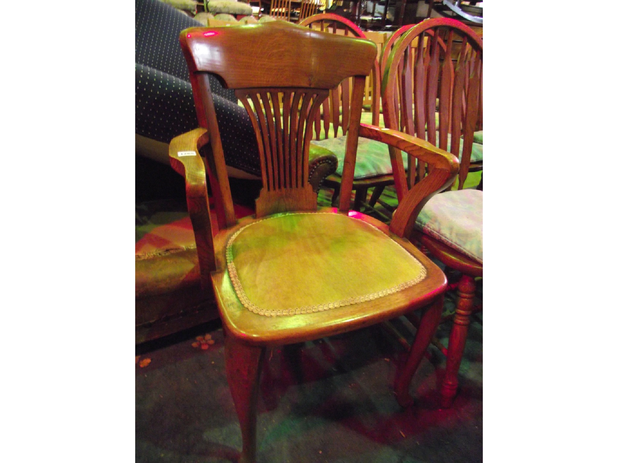 Appraisal: An Edwardian oak office desk chair with central combed splat