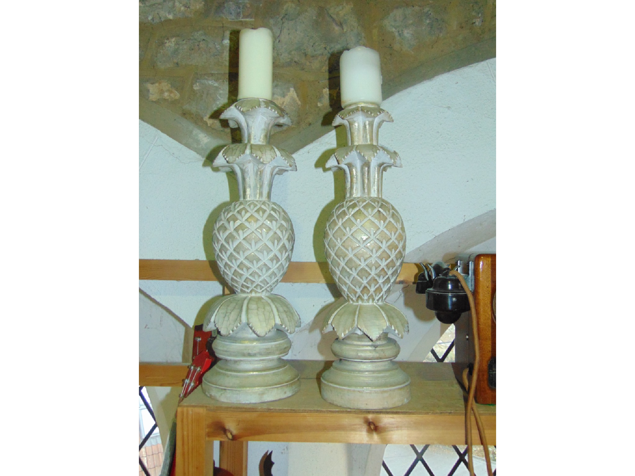 Appraisal: A contemporary decorative pair of cut timber candlesticks in the