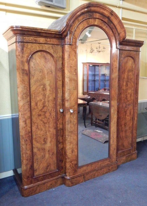 Appraisal: A Victorian figured walnut breakfront wardrobe the arched central section