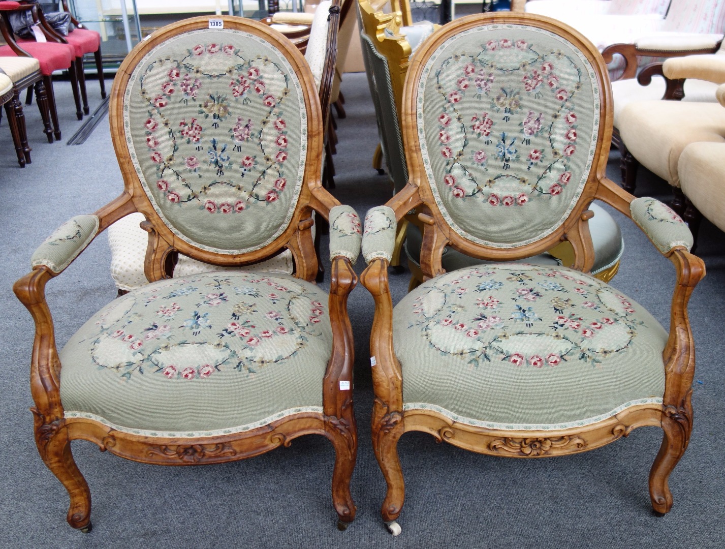 Appraisal: A pair of Victorian satinwood open armchairs with serpentine seats