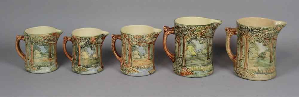 Appraisal: FIVE WELLER POTTERY FOREST PATTERN MILK JUGS decorated with continuous