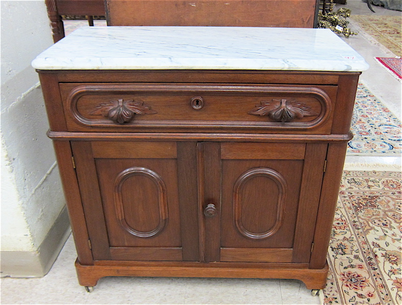 Appraisal: VICTORIAN MARBLE-TOP WALNUT WASHSTAND COMMODE American c having a rectangular