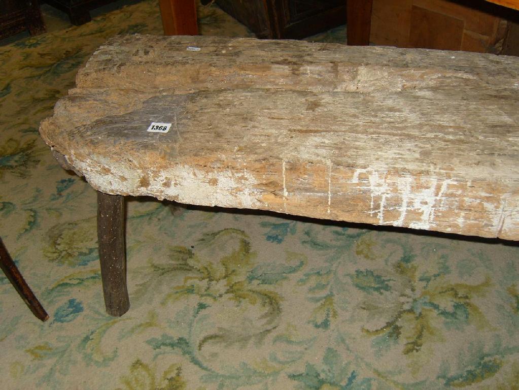 Appraisal: A rustic oak pig bench raised on simple stick supports