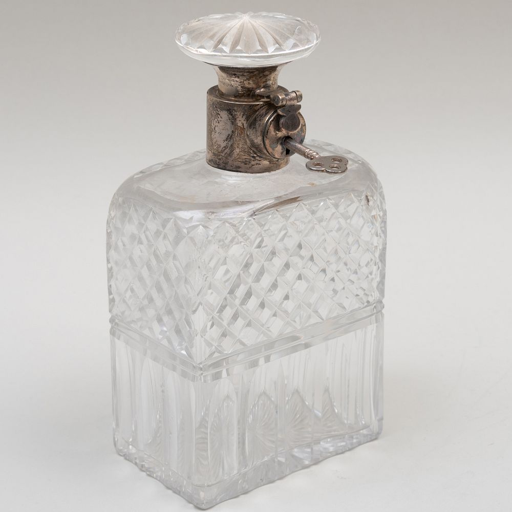 Appraisal: British Silver-Mounted Cut Glass Tantalus Decanter Marked with lion passant