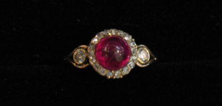 Appraisal: A CABOCHON RUBY AND DIAMOND DRESS RING the central cabochon