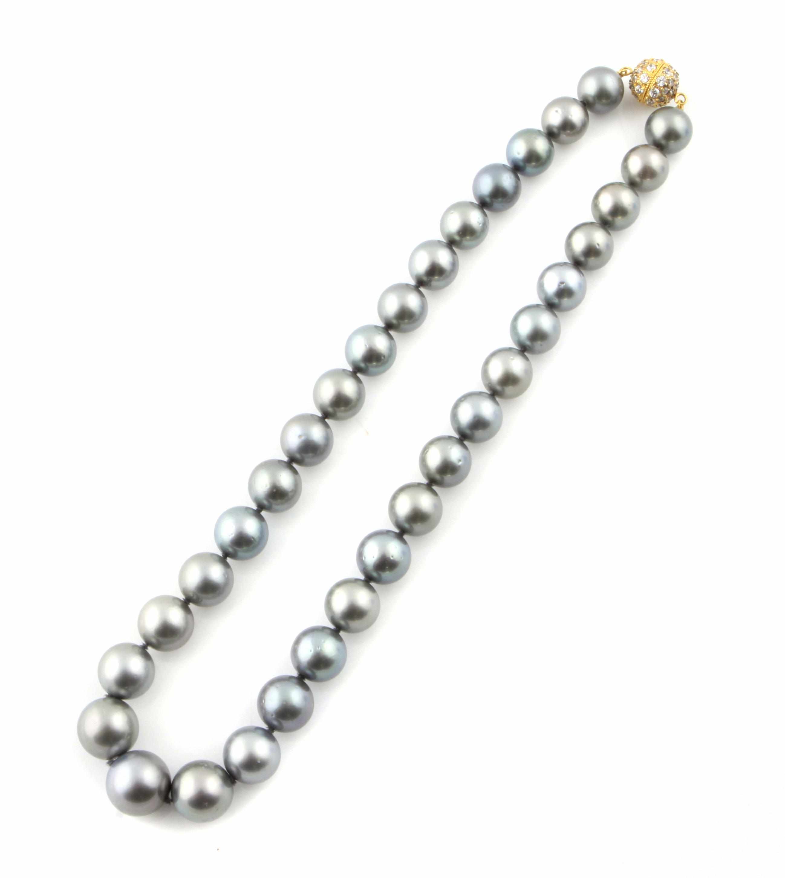 Appraisal: A black cultured pearl necklace with a diamond and gold