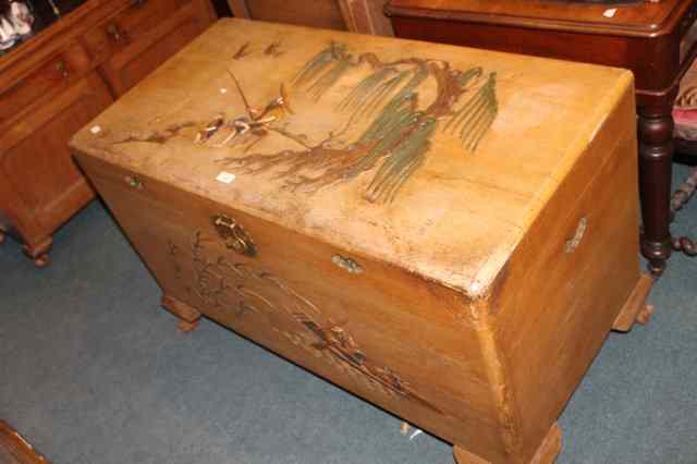 Appraisal: A CAMPHOR WOOD COFFER with polychrome chinoiserie relief decoration showing