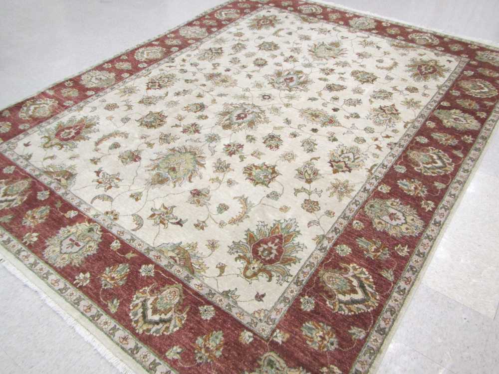 Appraisal: HAND KNOTTED ORIENTAL CARPET Pakistani Persian overall floral Isfahan design