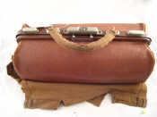 Appraisal: A leather Gladstone bag complete with protective canvas cover