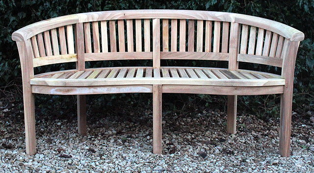 Appraisal: A TEAK GARDEN BENCH of curved form with a slatted