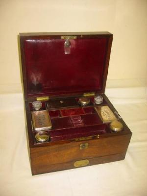 Appraisal: A ROSEWOOD TOILET BOX of oblong form with brass inlay