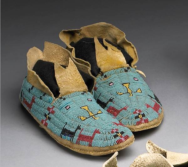 Appraisal: A pair of Cheyenne beaded moccasins On rawhide soles decorated