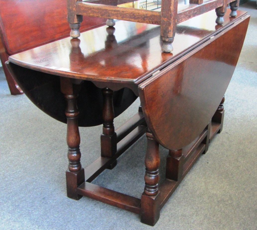 Appraisal: A large th century design oak drop flap dining table