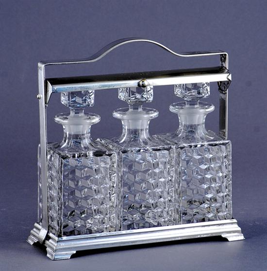 Appraisal: Silverplate and crystal tantalus circa three decanters within frame engraved