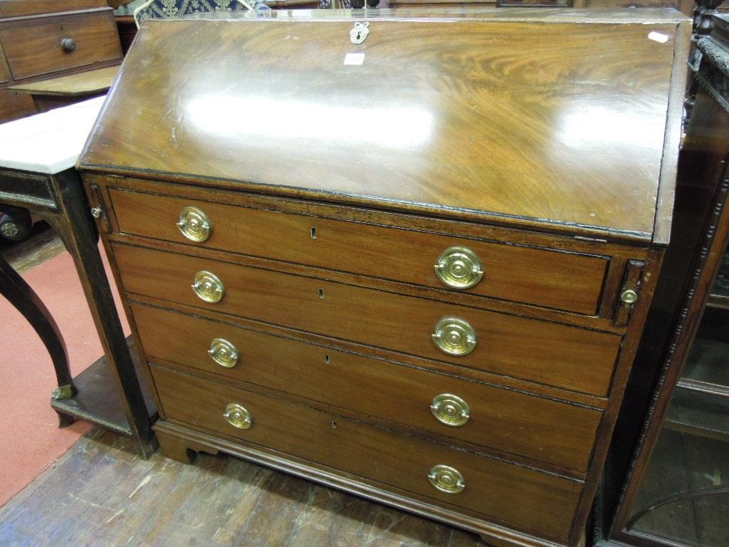 Appraisal: A Georgian mahogany bureau the flame veneered fall front enclosing