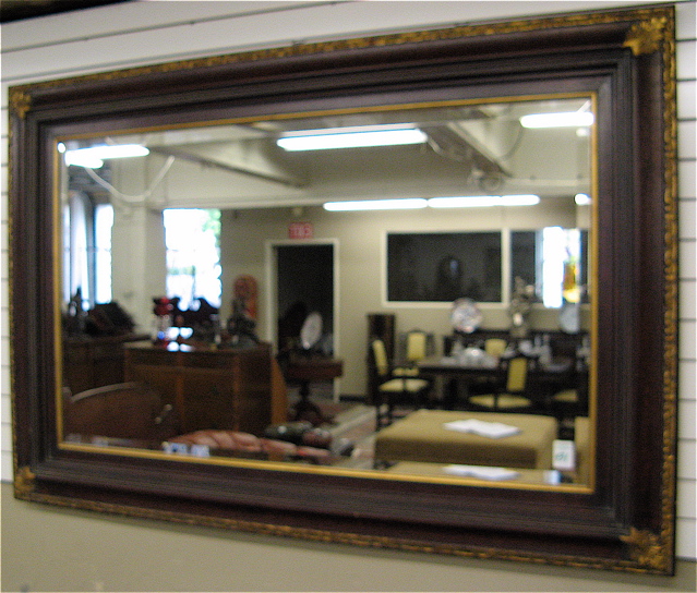 Appraisal: LARGE BEVELED GLASS WALL MIRROR in molded wood frame with