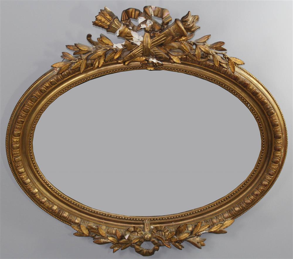 Appraisal: CONTINENTAL NEOCLASSICAL STYLE CARVED AND GILT OVAL MIRROR late th