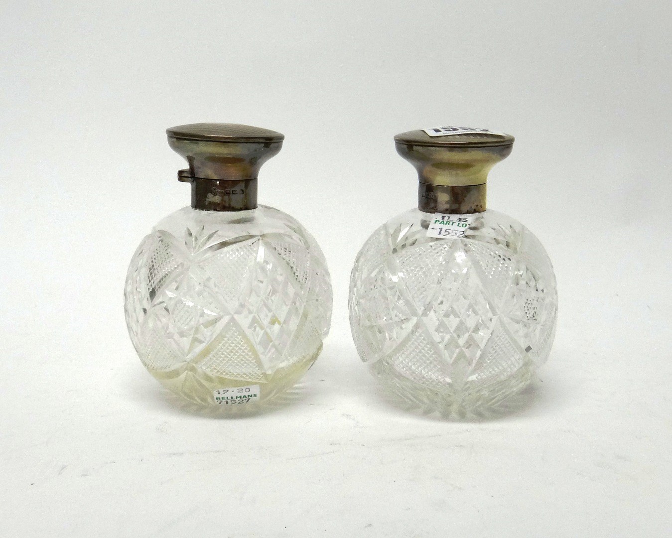 Appraisal: A pair of silver mounted faceted glass hinge lidded scent