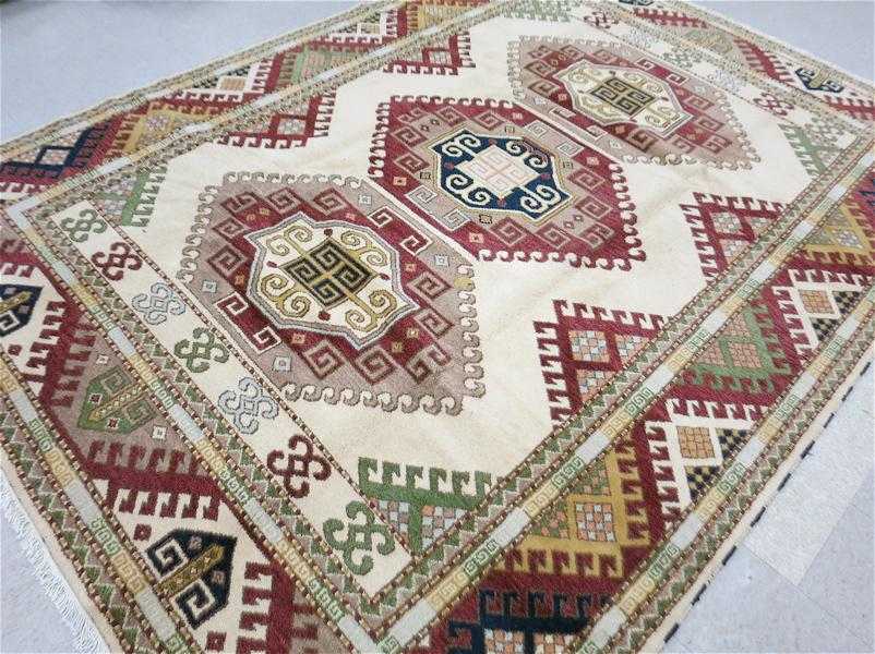 Appraisal: HAND KNOTTED ORIENTAL CARPET Indo-Kazak featuring three large hexagonal latch-hook