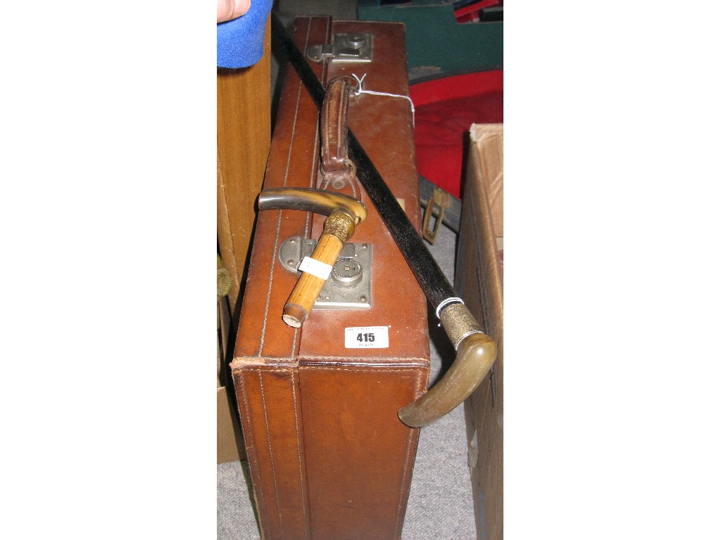 Appraisal: Lot comprising suitcase walking stick and a stick handle