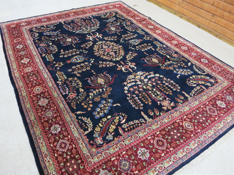 Appraisal: HAND KNOTTED ORIENTAL CARPET Indo-Sarouk floral sprig design on dark