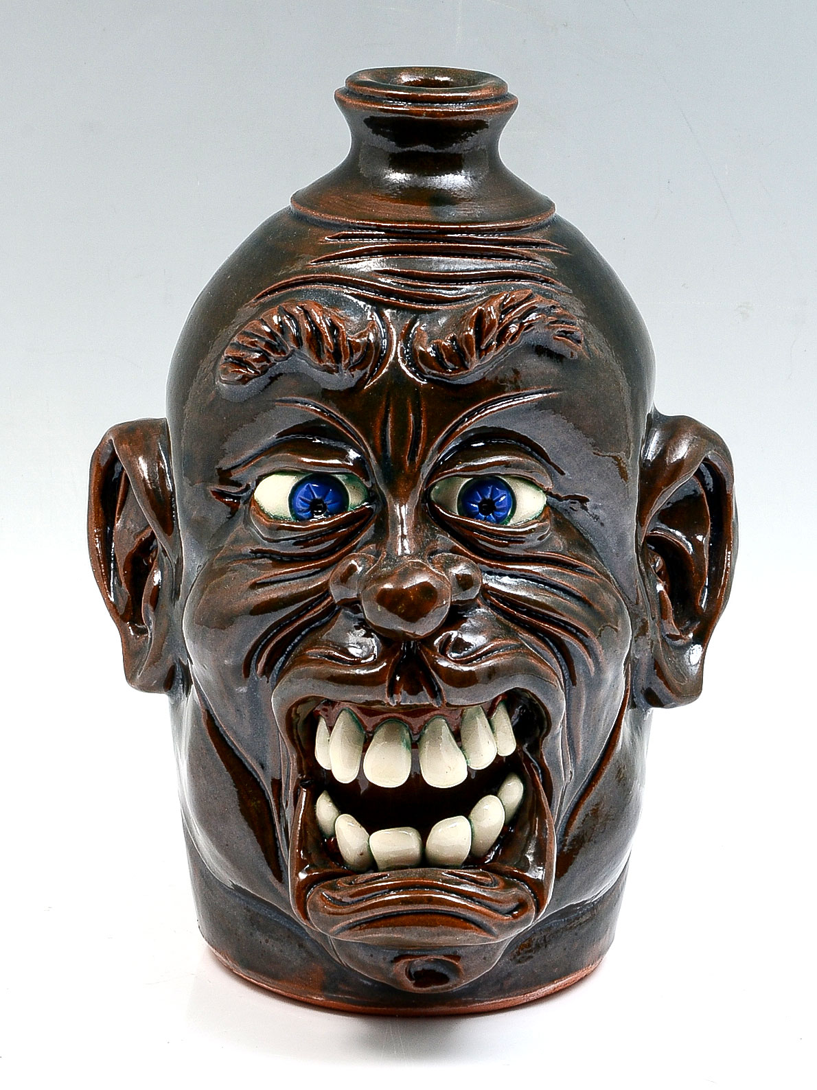 Appraisal: GEORGIA ''WAYNE CROCKER'' POTTERY FACE JUG Incredibly detailed face jug