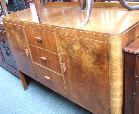 Appraisal: A th century walnut dining suite by 'Heals Tottenham Court