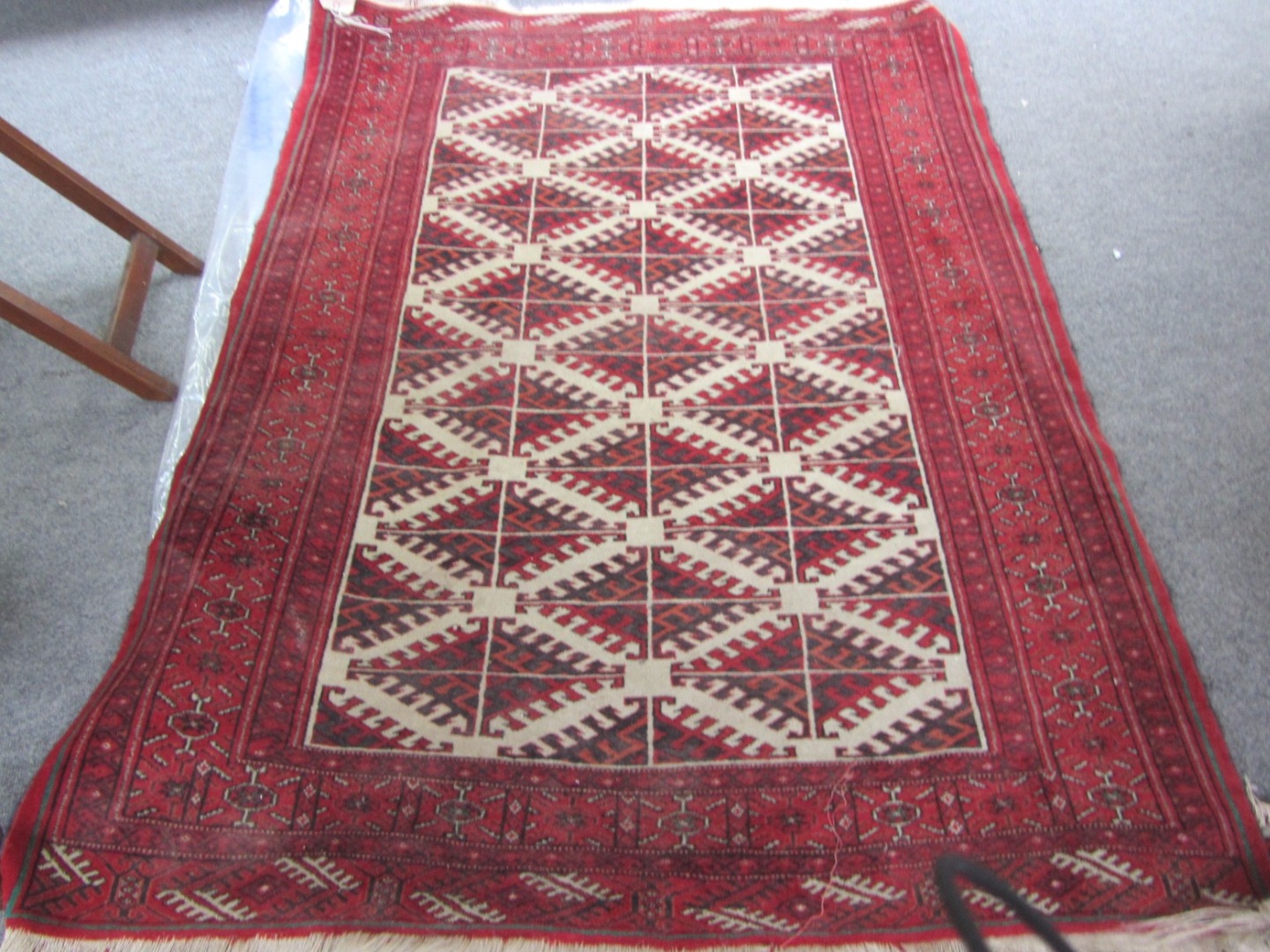 Appraisal: A Turkman rug the ivory field with diagonal diamond guls