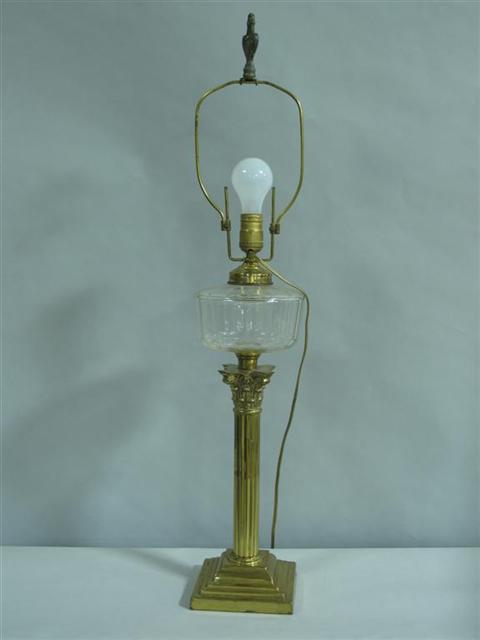 Appraisal: BRASS AND GLASS OIL LAMP With paneled globular font above