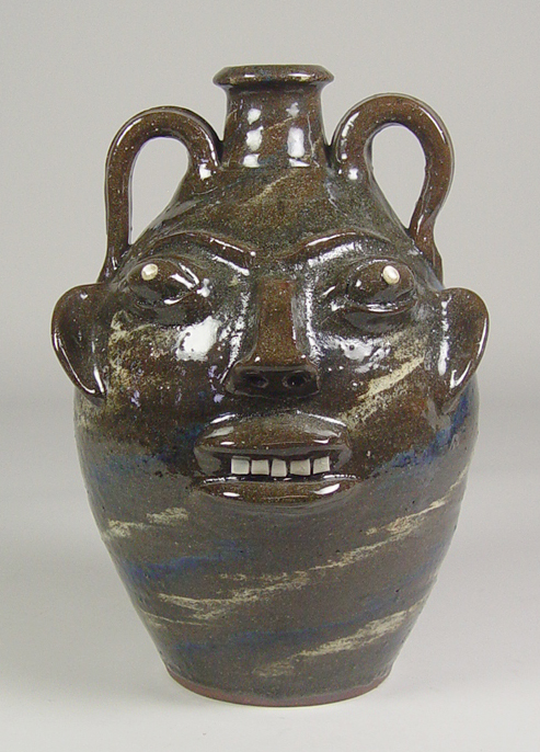 Appraisal: Face Jug by Walter Fleming Late th Century Brown alkaline