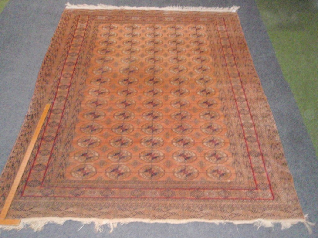 Appraisal: A Bokhara multi-gul rug beige ground cm x cm