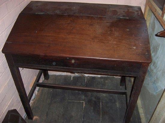 Appraisal: A clerk's mahogany desk the hinged writing slope enclosing a