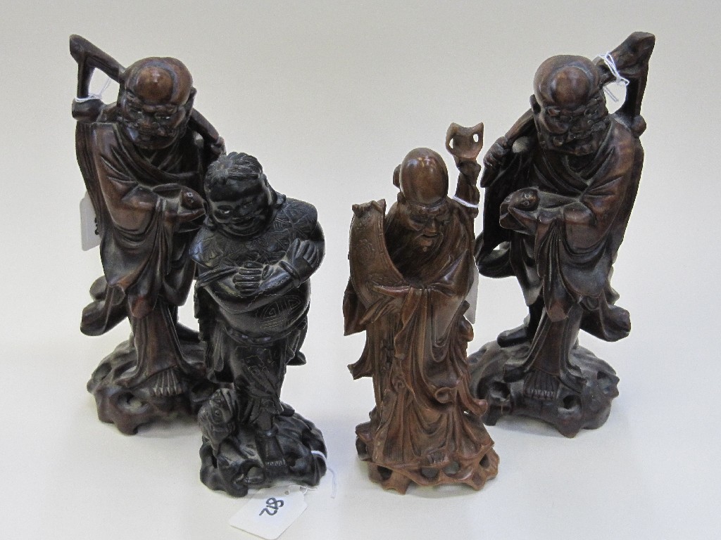 Appraisal: Four carved Chinese wooden figures of sages - one silver