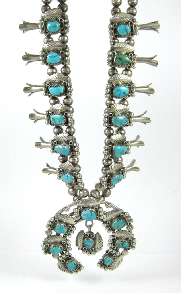 Appraisal: NAVAJO SQUASH BLOSSOM NECKLACE featuring silver tri-pedal blossoms each set