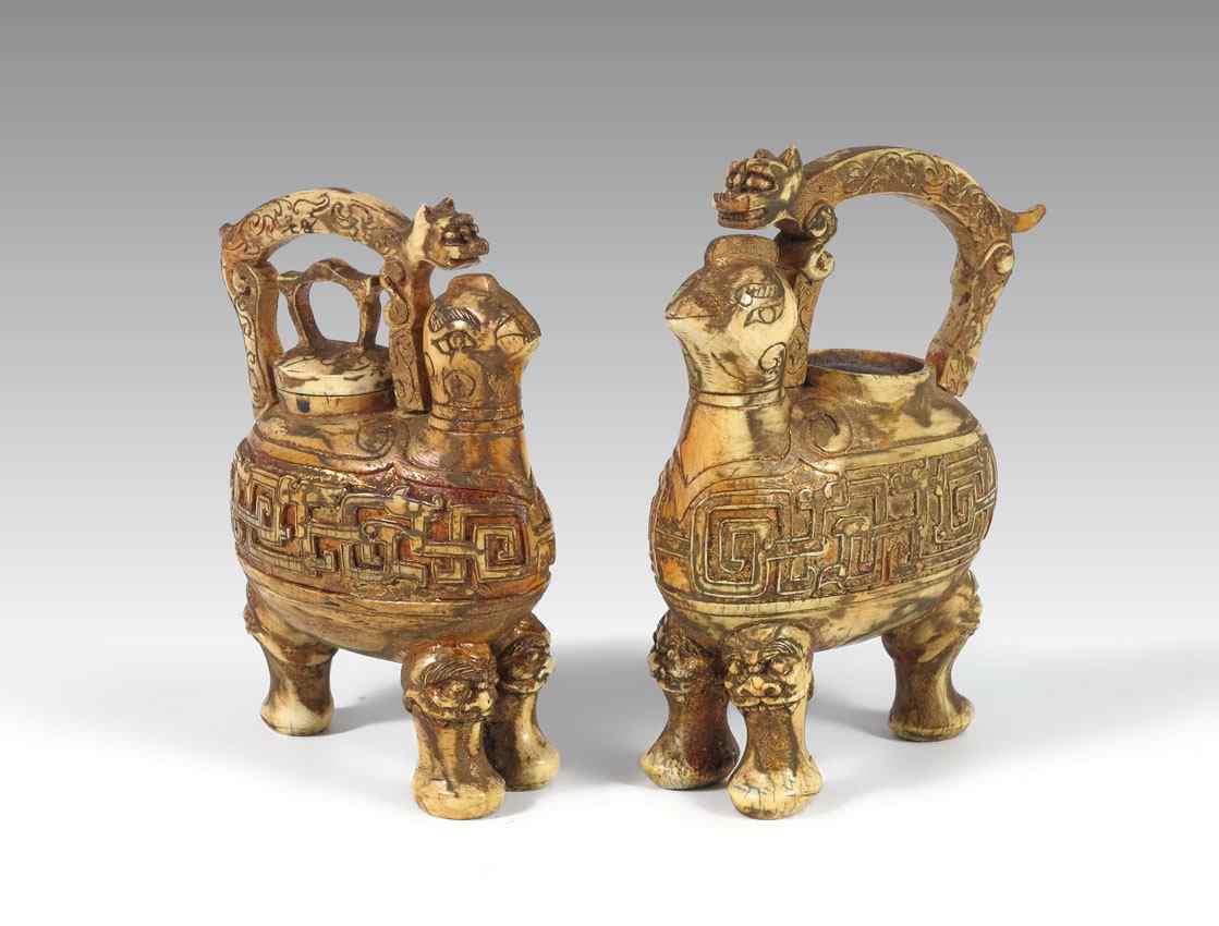 Appraisal: PAIR GILT DECORATE FIGURAL CARVED IVORY URNS Figures of legged