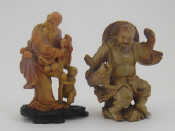 Appraisal: Two well carved Chinese soapstone groups one a man playing