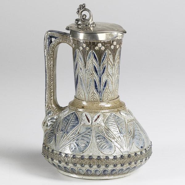 Appraisal: MARTIN BROS Lidded pitcher decorated with leaves and flowers and