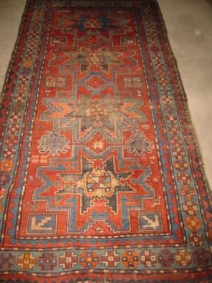 Appraisal: A KAZAK RUG the red field with four Lesghi stars