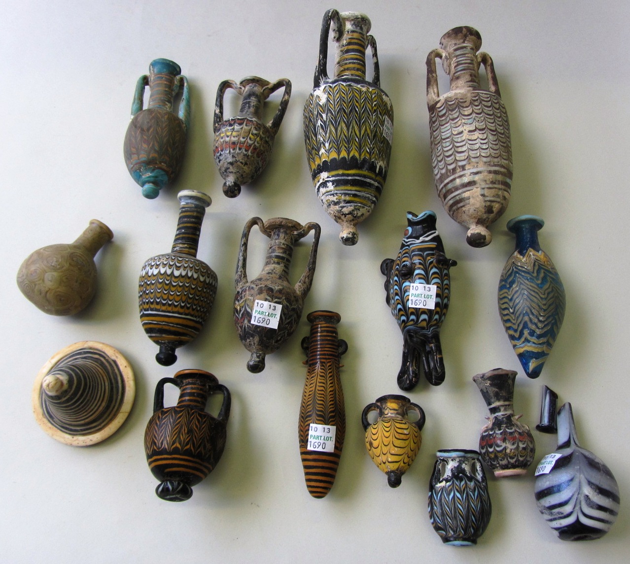 Appraisal: A group of core-formed style amphorae and other vessels Not